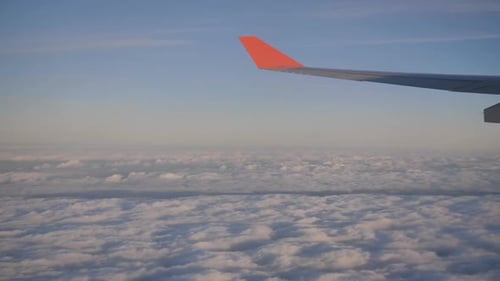 Flying and Traveling View From Airplane Window on the Wing on Sunset Time