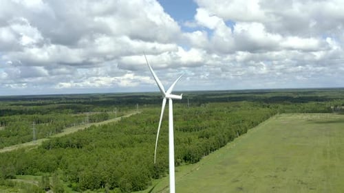 Bright and vivid wind turbine shoot. Orbiting establishing shoot revealing more wind turbines