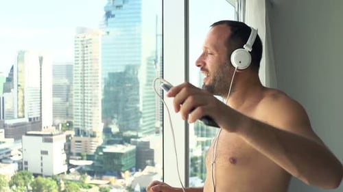 Man Listening Music and Dancing at Home