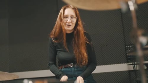 Professional Woman Drummer Playing Drums in a Soundproof Studio