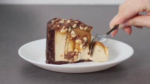Decadent Caramel Cheesecake Slice Being Served