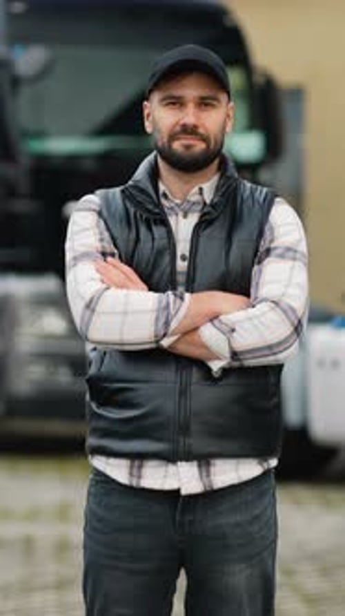 Man Smiling in Front of a Black Truck