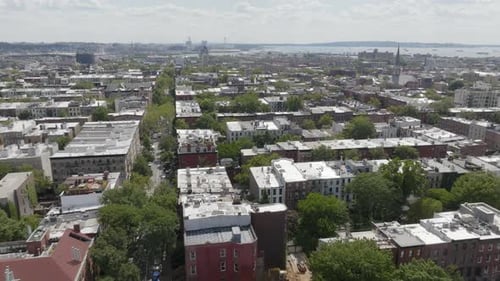 The row houses of Cobble Hill are accented by tree-lined streets in Brooklyn