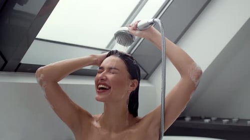 Young Carefree Lady Singing Song and Dancing Enjoying Morning Shower Procedures at Home Tracking
