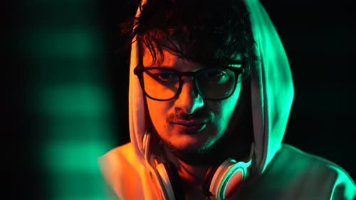 Man in Hoodie WIth Glasses Working on Computer From 1990's, Portrait Close Up