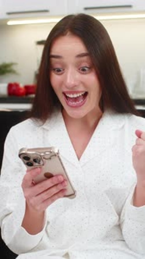Excited Brunette Woman Reacting to Phone News