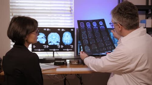 Doctor Discussing Brain Scan with Patient in Office