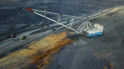An Aerial View Showcasing Heavy Machinery Utilized in Mining Operations and Activities Stock Clip