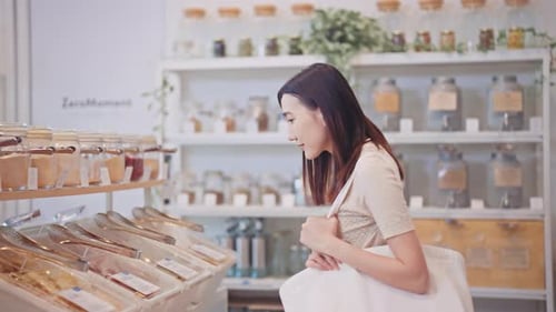 Young woman browsing products in a zero waste refill store