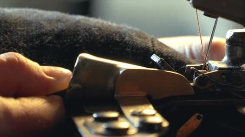 A Female Tailor Hemming Old Jeans with Vintage Machine