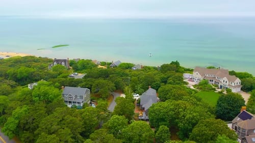 Cape Cod Aerial of Shoreline with Houses and Boat Offshore