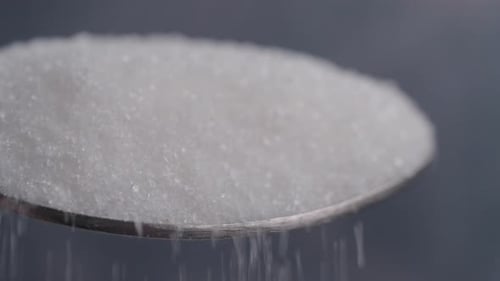 Detailed CloseUp of Granulated Sugar Piled on a Spoon for Visual Appeal