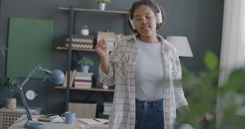 Woman Dancing at Home Listening to Music
