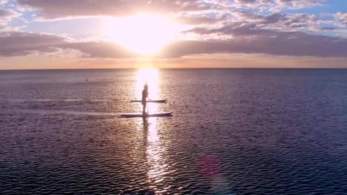 Two Paddleboarders at Sunset Activity