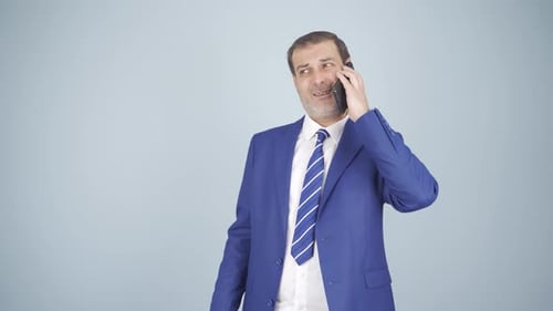 Man in Blue Suit Talking on the Phone