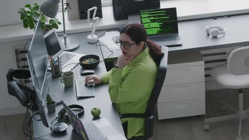 Middle Eastern Woman Coding on Computer in Office