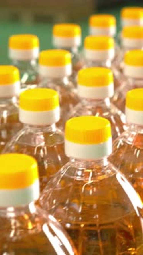 Closeup View of Multiple Plastic Bottles with Yellow Caps Arranged in a Vibrant Display