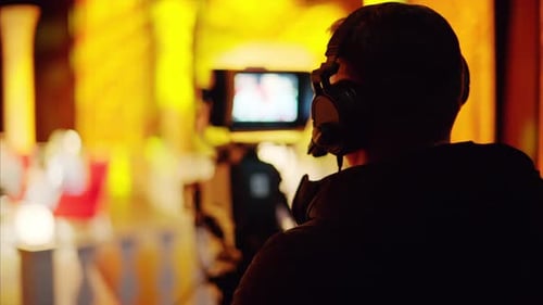 Cameraman Filming Performance in Dark Urban Setting