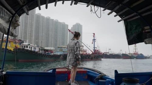 Girl Standing on a Boat in the Bay at the Port of Hong Kong
