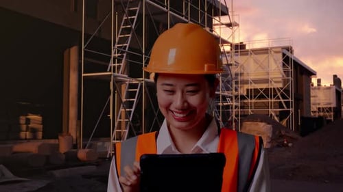 Close Up Of Asian Female Engineer Working On A Tablet At Building Site