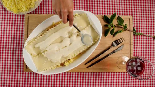 Woman Preparing Homemade Lasagna with Fresh Ingredients