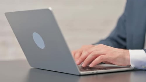 Close up Businessman Hands Typing on Laptop