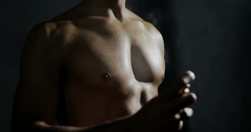 Muscular Torso Sprays Body with Product