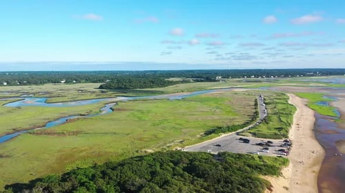 Cape Cod Aerial Drone Footage of Marsh and Beach Front Houses at Low Tide with People and Tall Green