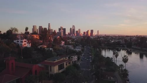 LA: Drone shot of Echo Park Lake rising up to reveal the Downtown skyline in the distance at sunset
