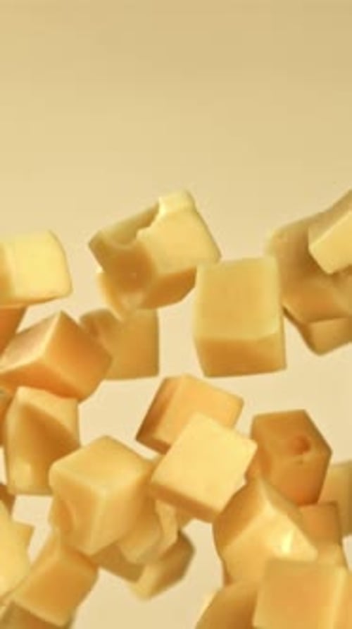 Cubes of Maasdam Cheese Fly on a Light Background Filmed on a Highspeed Camera at 1000 Fps