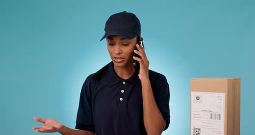 Phone call, box of courier and angry woman talk, chat or shipping in studio isolated on a blue