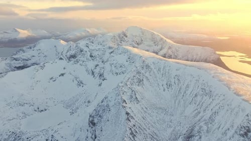 The Majestic Snowy Mountains at Sunset Provide a Breathtaking View Overlooking a Serene Landscape