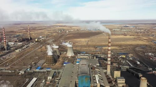 Aerial View of Thermal Power Plant Drone Flies Over Chimney Smoke Pipes and Cooling Towers of