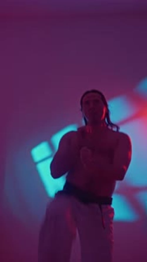 Martial Arts Intensity Intense Martial Arts Demonstration Under Vibrant Colored Lighting Caucasian
