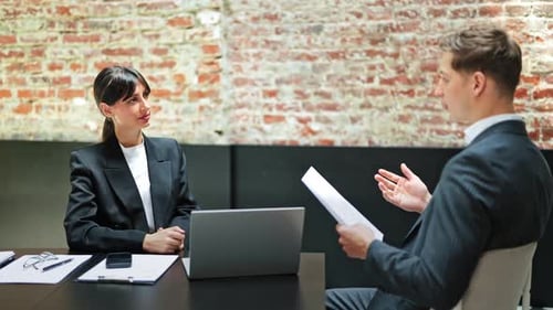 Business Meeting Professionals Discussing Documents in Modern Office