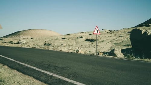 Twisting Road Through the Rugged Landscape of Mongolia Under Clear Skies