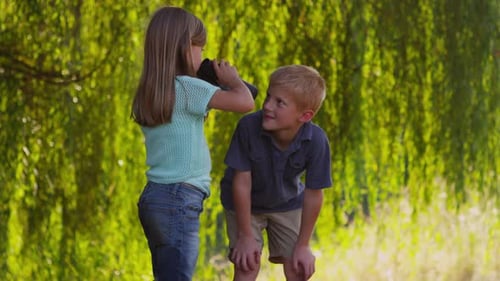 Young Children Exploring Nature With Binoculars Outdoors