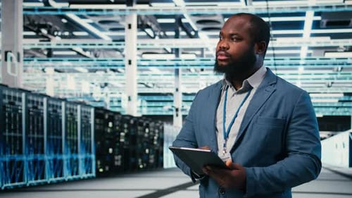 Man Using Tablet in Data Center Server Room