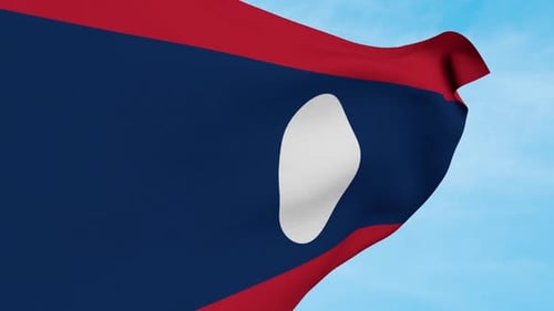 Waving National Flag of Laos Against a Blue Sky