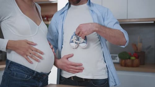 Loving Couple Expecting a Baby in Home Kitchen