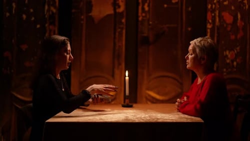 Women Discussing Tarot Cards by Candle Light