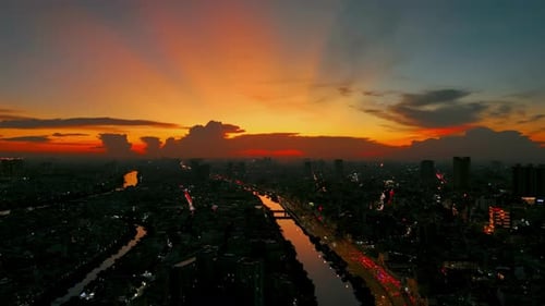 Vibrant Cityscape with River at Colorful Sunrise
