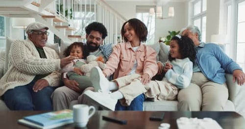 Smiling Family Sits Together on Couch