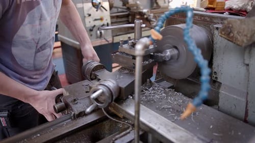 Man Operating Lathe in Manufacturing Workshop