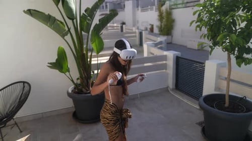 Woman Enjoys Virtual Reality on Sunny Patio