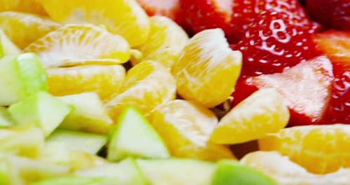 of fresh fruit mix composition, with strawberry, apple,blueberry,raspberry,kiwi, orange. Salad of