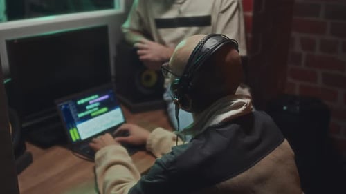 Unidentified Producer Controlling Process of Song Recording in Studio