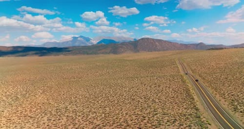Motorway leading to the beautiful mountains of Nevada through the desert.