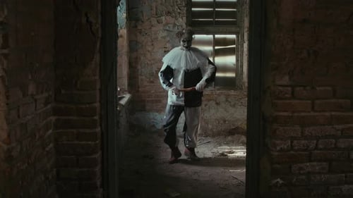 Scary Clown Dancing with Axe in Abandoned Building