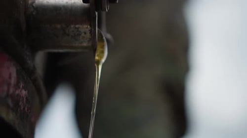 Close-up of a honeycomb extractor flows out honey. Slow motion 120p